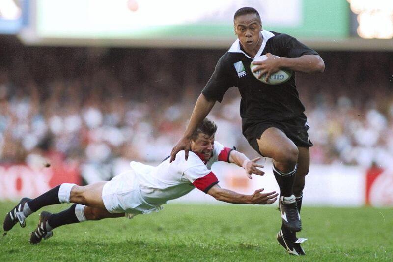 Cape Town - 18 Jun 1995:  Jonah Lomu of New Zealand evades the diving tackle of Rob Andrew of England during the Rugby World Cup Semi Final at the Newlands Stadium in Cape Town, South Africa. New Zealand won the match 45-29.  \ Mandatory Credit: Simon Bruty /Allsport