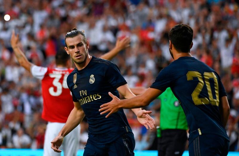 Real Madrid's Welsh forward Gareth Bale (L) celebrates with Real Madrid's Spanish midfielder Marco Asensio after scoring a goal during the International Champions Cup football match between Real Madrid and Arsenal at FedExField in Landover, Maryland, on July 23, 2019.  / AFP / ANDREW CABALLERO-REYNOLDS
