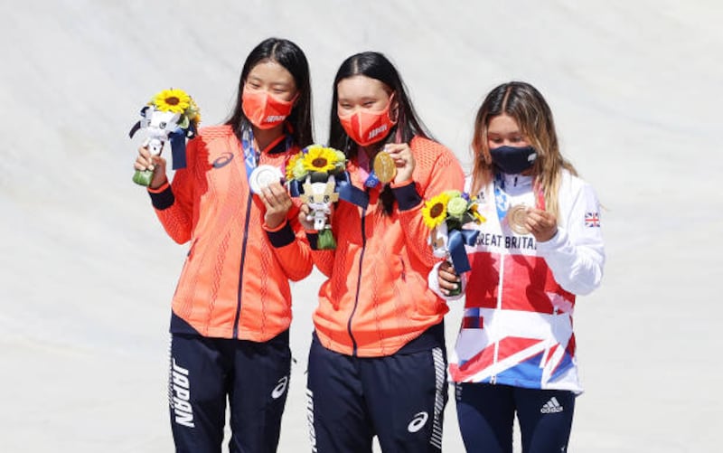 Bronze medalist Sky Brown of Team Great Britain (right); gold medalist Sakura Yosozumi of Team Japan, centre, and silver medalist Kokona Hiraki of Team Japan (pose after the Women's Skateboarding Park Finals.
