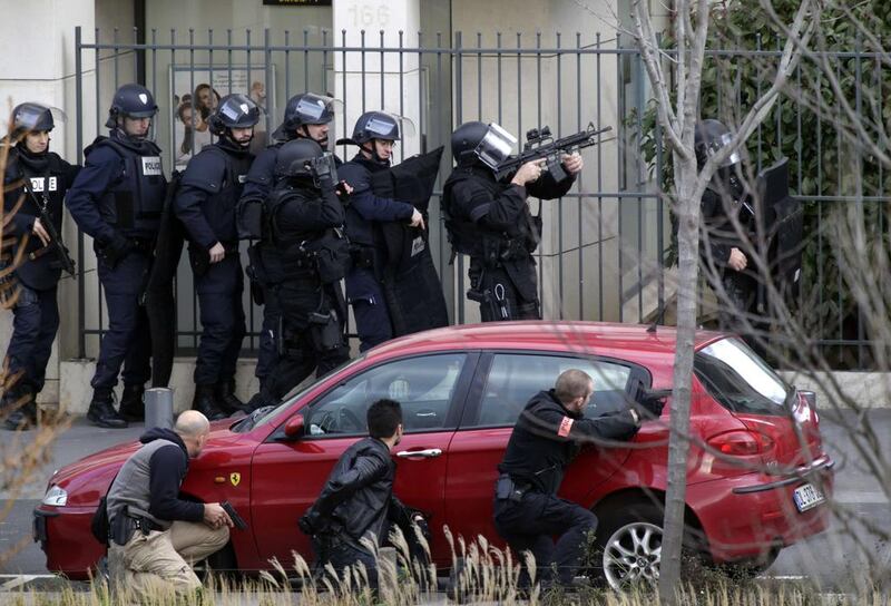 French security forces staged near the post office where an armed man was holed up with two hostages on January 16 in Colombes, outside Paris. The man was later arrested. AFP Photo