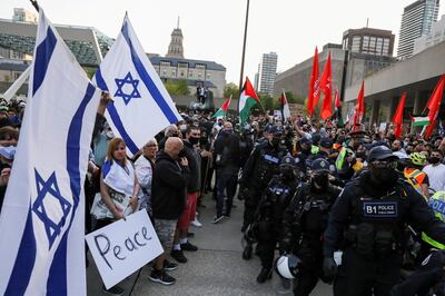 Police officers stand in line to separate protesters supporting Palestine from a small group of Israel supporters in front of city hall in Toronto, Ontario, Canada May 15, 2021. REUTERS/Chris Helgren     TPX IMAGES OF THE DAY
