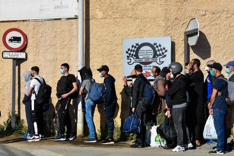 Moroccan citizens stranded in Spain due to coronavirus crisis, queue to take the coach that will repatriate them in the Spanish enclave of Ceuta.   AFP