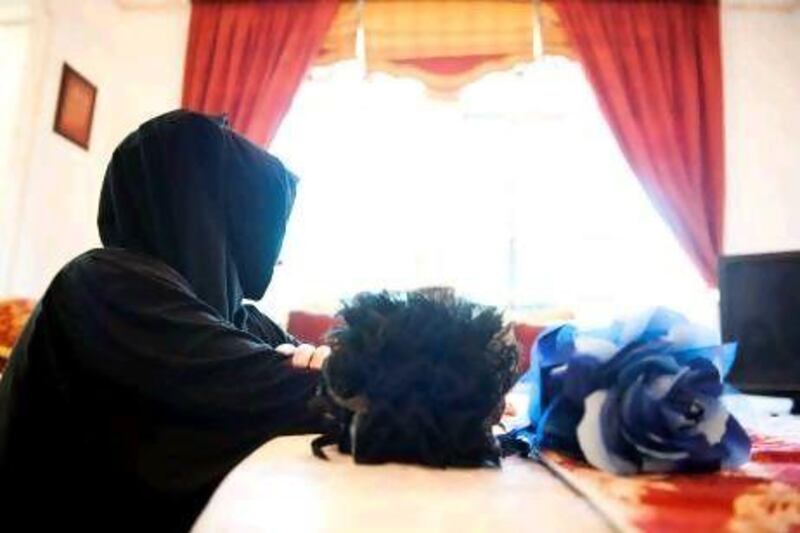 A young woman demonstrates how to wear a gamboo3a, a hair piece that adds volume to the crown. The accessory is a hairclip in the shape of a flower. Sarah Dea / The National