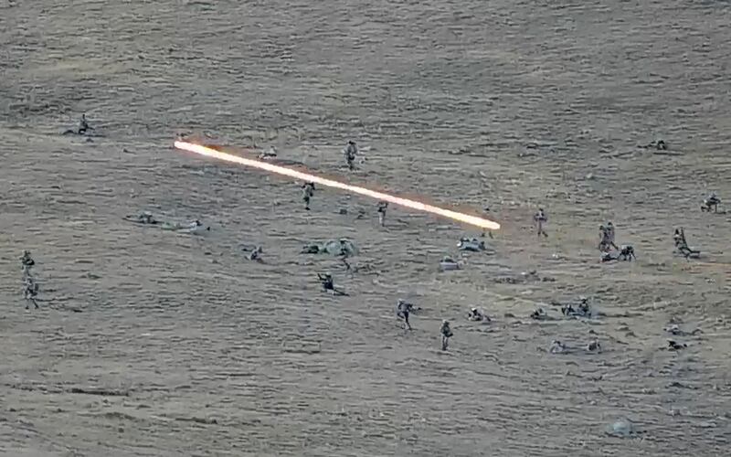 Azerbaijan's soldiers cross the border as they approach Armenian positions. AP