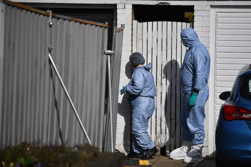 Members of a forensics team walk outside the home of a murder suspect in Deal, Kent, after the discovery of human remains in the grounds of Great Chart Golf and Leisure near Ashford. AFP