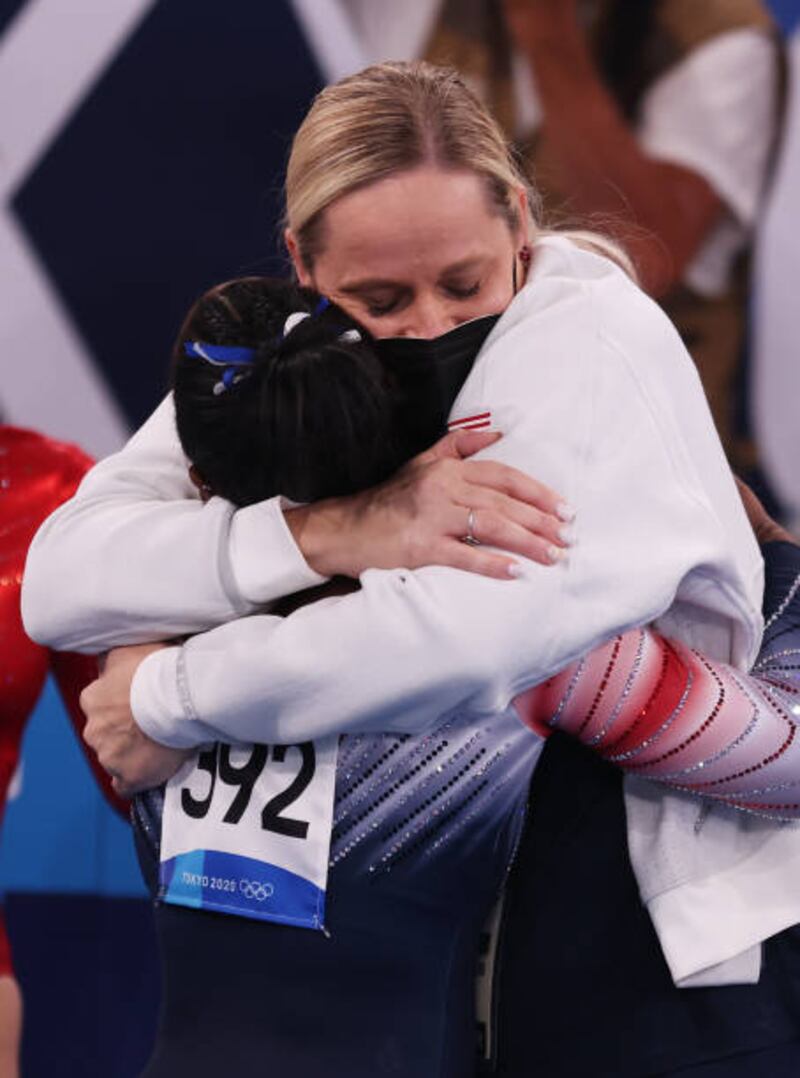 Simone Biles of Team United States and coach Cecile Canqueteau-Landi embrace.