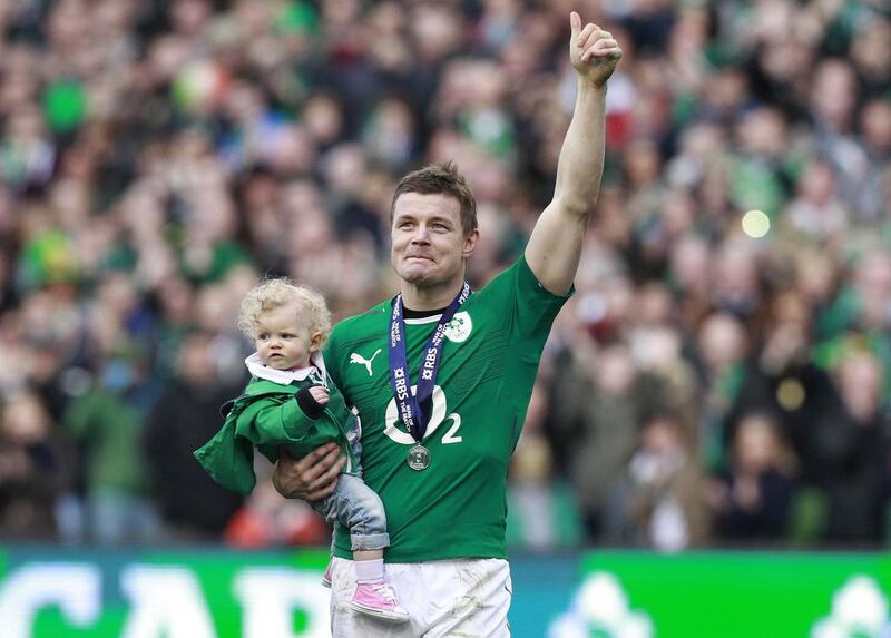 Ireland’s Brian O’Driscoll waves to spectators as he carries his daughter Sadie at the end of the Six Nations game against Italy at Aviva Stadium in Dublin, with Ireland convincing winners. Cathal McNaughton / Reuters


