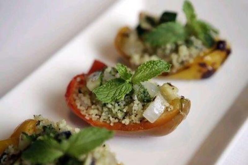Chilled stuffed peppers with pesto couscous salad and grilled vegetables is offered at Frankie's Restaurant & Bar.