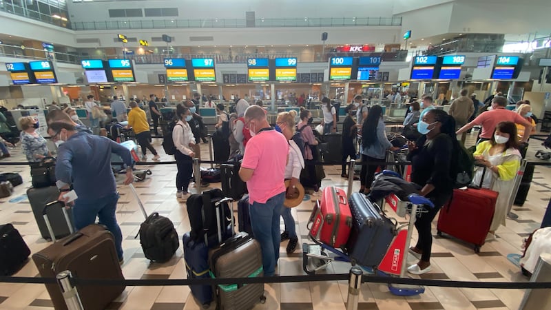 Travellers queuing in the hope of boarding an overbooked Lufthansa flight at Cape Town International Airport. Antonie Robertson / The National