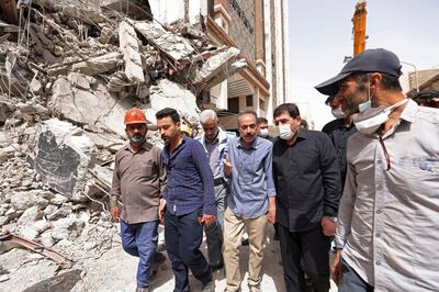 Iranian Vice President Mohammad Mokhber, second right, visits the site of a building collapse in Abadan. Iranian Senior Vice President Office via AP