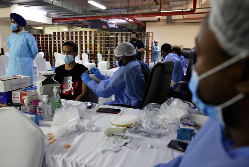 People are vaccinated against coronavirus at Dubai's Guru Nanak Darbar gurudwara (Sikh temple). Karim Sahib / AFP