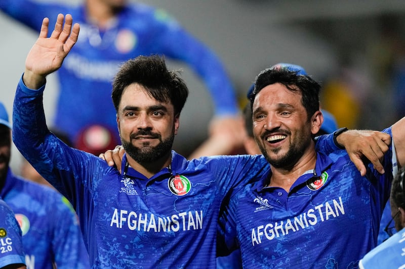 Afghanistan captain Rashid Khan, left, and teammate Gulbadin Naib celebrate after defeating Bangladesh by eight runs. AP