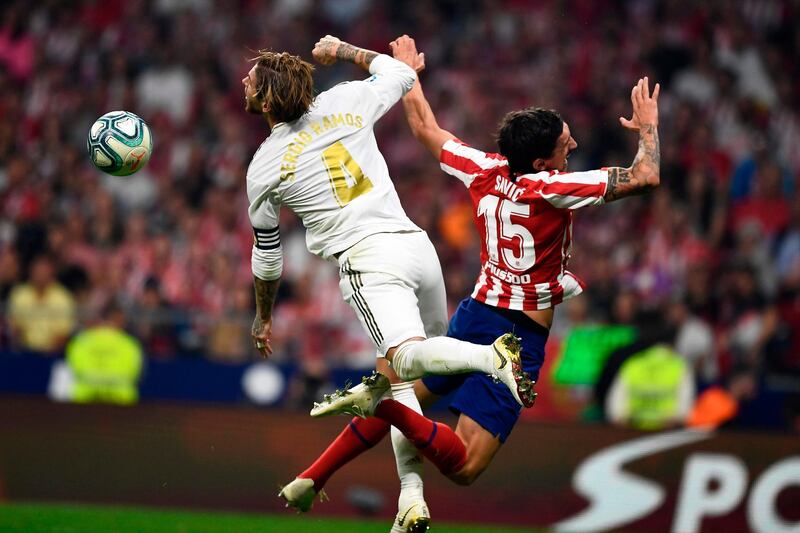 Real Madrid's Spanish defender Sergio Ramos and Atletico Madrid's Montenegrin defender Stefan Savic jump for the ball. AFP