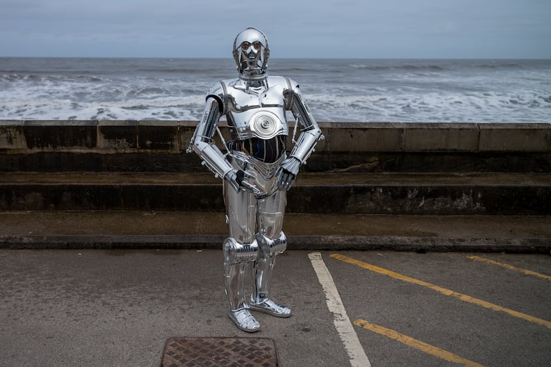 A man dressed as the TC-14 droid from Star Wars
