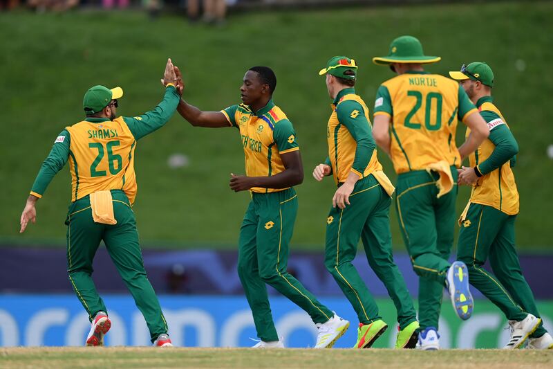 Kagiso Rabada of South Africa celebrates with teammates after taking the wicket of Nitish Kumar of the USA. Getty Images