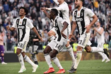Juventus' Portuguese forward Cristiano Ronaldo (C), his hair covered in foam, and (From L) Juventus' Colombian midfielder Juan Cuadrado, Juventus' French midfielder Blaise Matuidi and Juventus' German midfielder Emre Can acknowledge fans and celebrate after Juventus secured its 8th consecutive Italian 2018/19 "Scudetto" Serie A championships, after winning the Italian Serie A football match Juventus vs Fiorentina on April 20, 2019 at the Juventus stadium in Turin. / AFP / Marco Bertorello
