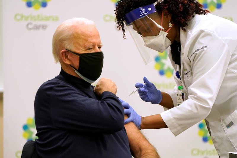 NEWARK, DE - DECEMBER 21: President-elect Joe Biden (L) receives a COVID-19 Vaccination from nurse practitioner Tabe Mase at ChristianaCare Christiana Hospital on December 21, 2020 in Newark, Delaware. The rollout of the Moderna vaccine, the second approved for use in the United States, began shipping to sites around the country today. (Photo by Joshua Roberts/Getty Images)