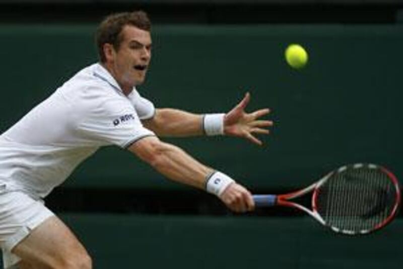 Andy Murray of Britain returns the ball to Viktor Troicki during their match at Wimbledon.