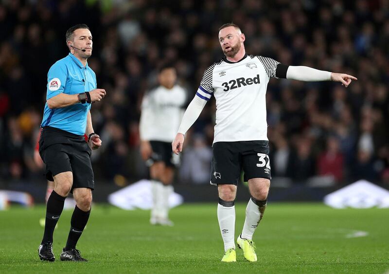 Derby County's Wayne Rooney talks with referee Dean Whitestone. AP