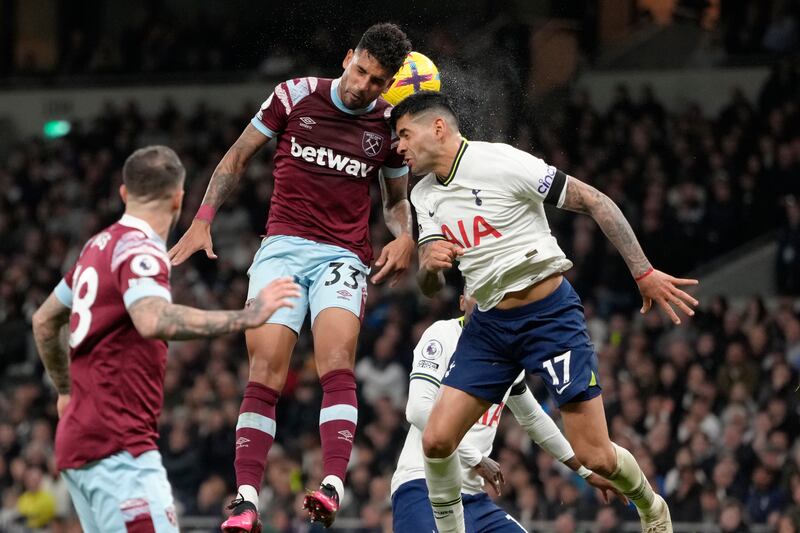 Tottenham's Cristian Romero, right, challenges for the ball with West Ham's Emerson Palmieri. AP 