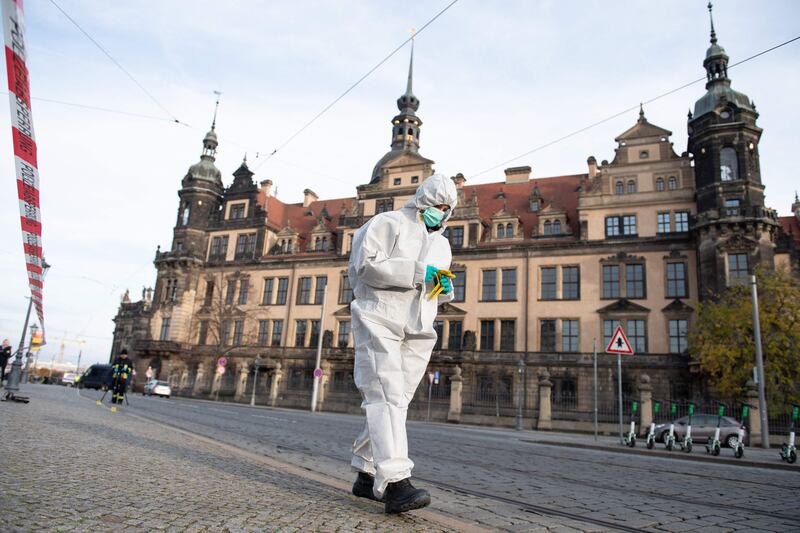 An investigator in forensic gear works behind a police cordon outside the historic Green Vault in Dresden. AFP