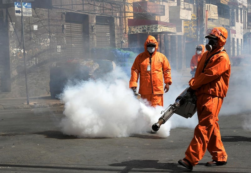 Municipal officials fumigate a street in Cochabamba, Bolivia. EPA