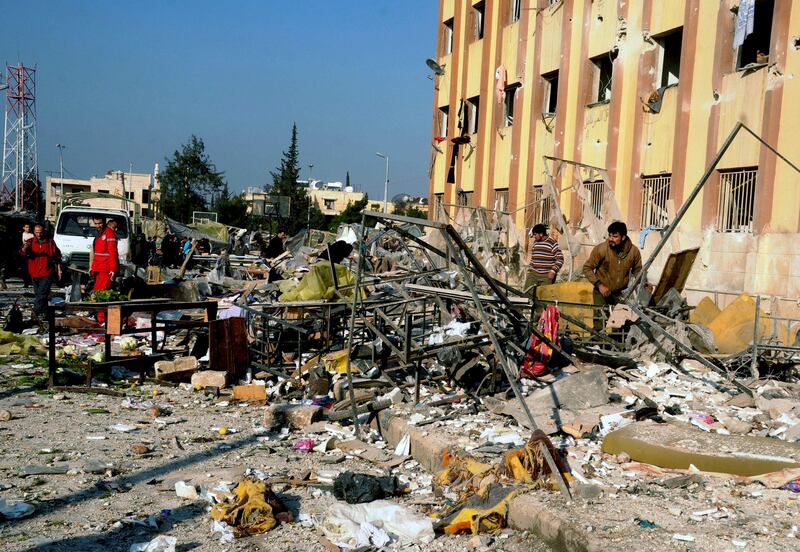 In this photo released by the Syrian official news agency SANA, Syrian people gather at the site after an explosion hit a university in Aleppo, Syria, Tuesday, Jan. 15, 2013. Two explosions struck the main university in the northern Syrian city of Aleppo on Tuesday, causing an unknown number of casualties, state media and anti-government activists said. There were conflicting reports as to what caused the blast at Aleppo University, which was in session Tuesday. (AP Photo/SANA) *** Local Caption ***  Mideast Syria.JPEG-0c59f.jpg