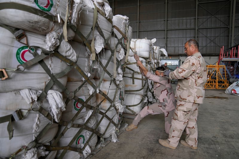 Iraqi security forces with humanitarian aid from Red Crescent meant for the affected people in Syria, at a military airbase near Baghdad International Airport. AP