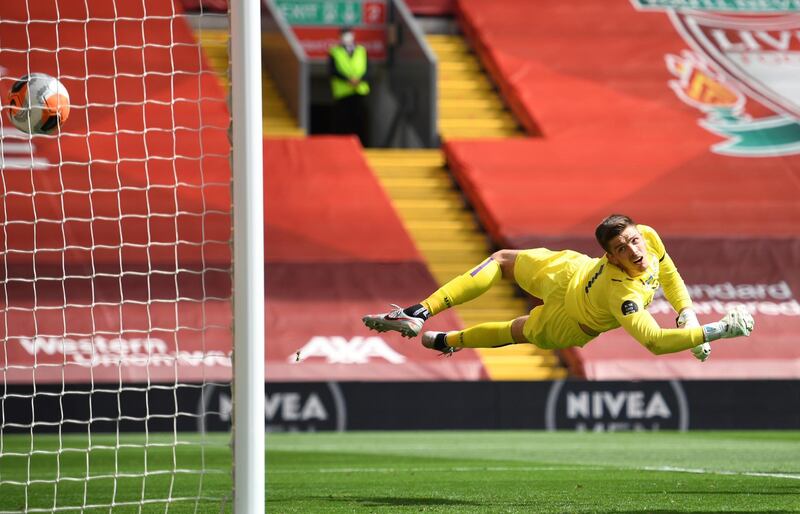 Burnley's goalkeeper Nick Pope dives in vain as Liverpool's Andrew Robertson's header goes past him for the opening goal at Anfield on Saturday. AP