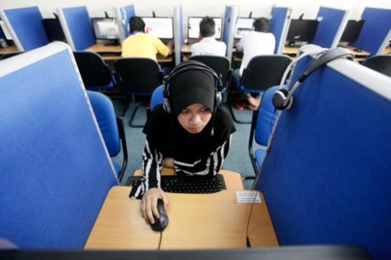 A woman browses the Internet at a cyber cafe in Putrajaya June 16, 2011. At least 41 Malaysian government websites were hacked into overnight but no personal or financial data were compromised, government officials said on Thursday, as the Southeast Asian nation becomes the latest target of a cyber-war waged by the activists. REUTERS/Bazuki Muhammad (MALAYSIA - Tags: SOCIETY SCI TECH BUSINESS CRIME LAW) *** Local Caption ***  BAZ01_CYBER MALAYSI_0616_11.JPG