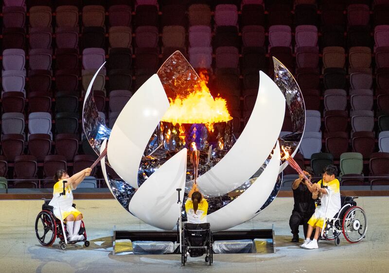 Handout photo dated 24/08/2021 provided by OIS of Torchbearers Yui Kamiji, Shunsuke Uchida and Karin Morisaki lighting the Paralympic flame during the opening ceremony of the Tokyo 2020 Paralympic Games at Olympic Stadium in Japan. Picture date: Tuesday August 24, 2021.