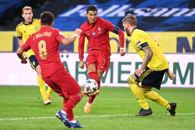 Cristiano Ronaldo shoots to score his second goal against Sweden. AFP