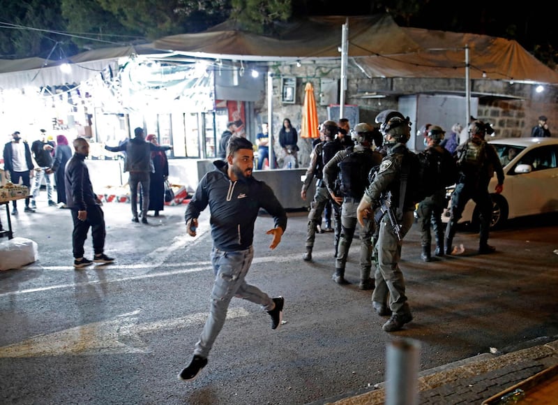 A Palestinian protester runs from Israeli security forces outside the Damascus Gate in Jerusalem's Old City, amid tensions following yesterday's clashes between Palestinians and far-right Jews.  AFP