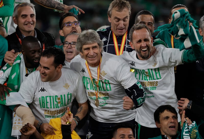 Real Betis coach Manuel Pellegrini celebrates with his players and coaches after winning the Copa del Rey. Reuters