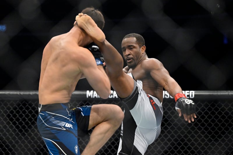 Geoff Neal, right, connects with a kick to Shavkat Rakhmonov. AP Photo 