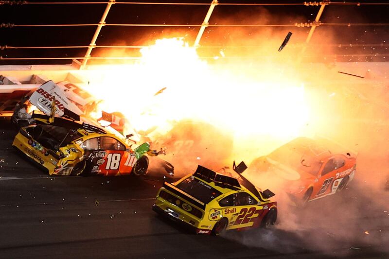 DAYTONA BEACH, FLORIDA - FEBRUARY 14: Brad Keselowski, driver of the #2 Discount Tire Ford, Kyle Busch, driver of the #18 M&M's Toyota, Joey Logano, driver of the #22 Shell Pennzoil Ford, and Bubba Wallace, driver of the #23 DoorDash Toyota, are involved in an on-track incident during the NASCAR Cup Series 63rd Annual Daytona 500 at Daytona International Speedway on February 14, 2021 in Daytona Beach, Florida.   James Gilbert/Getty Images/AFP
== FOR NEWSPAPERS, INTERNET, TELCOS & TELEVISION USE ONLY ==
