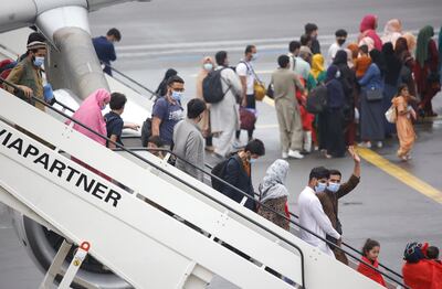 People arrive at Melsbroek Military Airport, Belgium, after being flown out of Kabul. Photo: AP