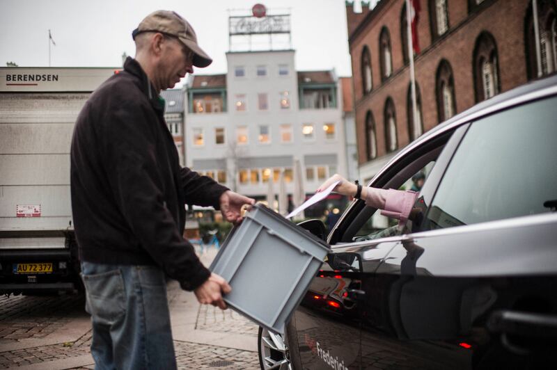 A voter casts her ballot from a car at a drive-in polling station in front of the town hall in Odense, about 165km west of Copenhagen. AFP