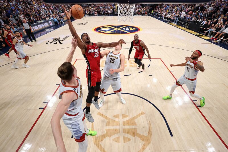 Miami Heat forward Jimmy Butler reaches for the ball against the Denver Nuggets. USA Today