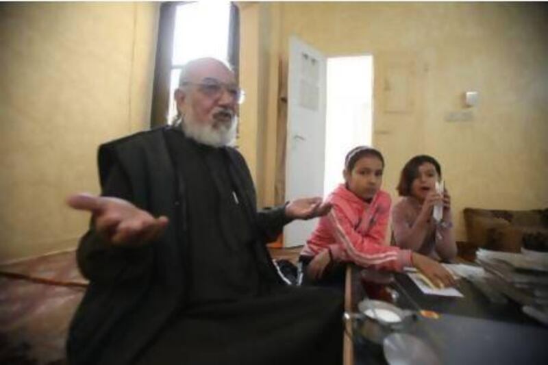 Abdel Halim Qteishat with his daughters at home in Al Baqaa camp for Palestinian refugees, north Amman.