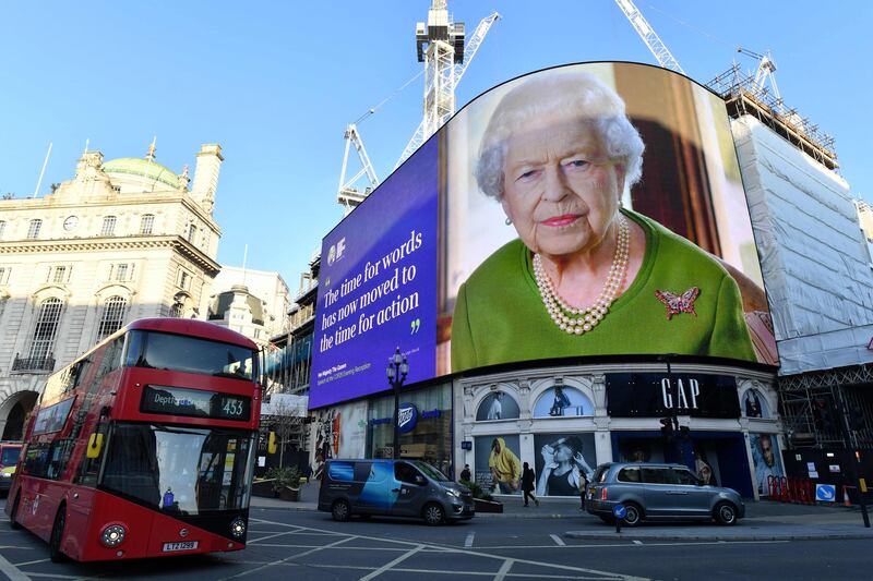 A quote from a message delivered by Britain's Queen Elizabeth to the Cop26 Summit taking place in Glasgow is displayed at Piccadilly Circus in London. AFP