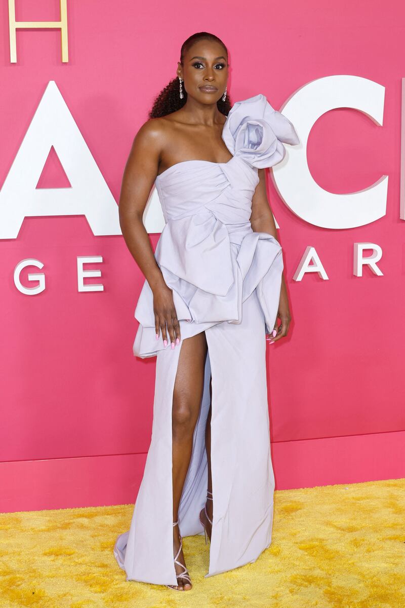 Issa Rae wears a lilac gown with an oversized flower detail. AFP