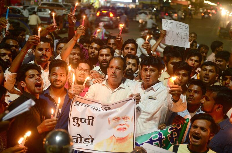 (FILES) In this file photo taken on April 13, 2018 Indian Congress workers participate in a candle light procession as they shout slogans against Indian Prime Minister Narendra Modi during a protest against rape incidents, in Allahabad.
Indian police have made another arrest after the alleged rape of a teenager by a ruling party politician fanned protests across the country, federal investigators said April 15.
 / AFP PHOTO / SANJAY KANOJIA