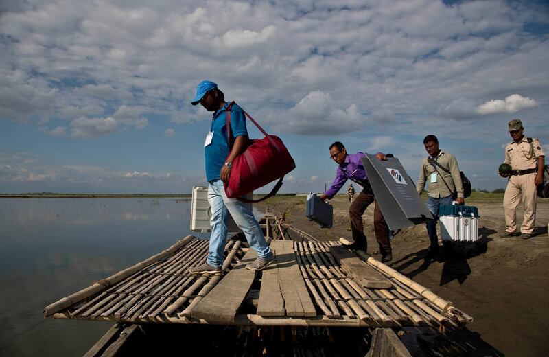 Indian election officials and paramilitary soldiers with election materials board on a country boat to cross the river Brahmaputra on the eve of first phase of general election in Majuli, Assam, India. Voting will take place in seven phases over six weeks beginning Thursday. Nearly 900 million people, including 15.9 million first-time voters, are eligible to cast ballots in the world's largest democratic exercise. AP Photo