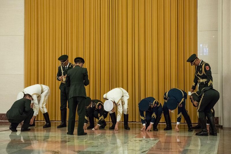 Chinese People's Liberation Army personnel prepare for the arrival of the Ivory Coast's President Alassane Ouattara at the Great Hall of the People in Beijing. AFP