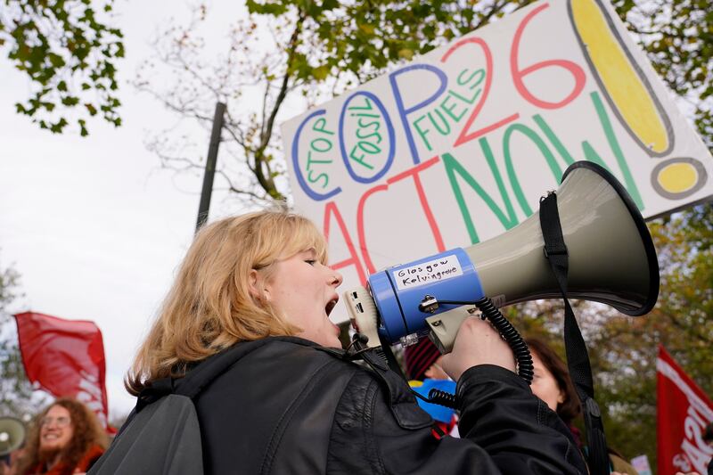 A young climate activist speaks through a megaphone. AP Photo