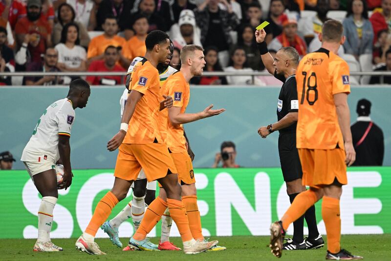 Brazilian referee Wilton Sampaio gives a yellow card to Netherlands' defender Matthijs De Ligt. AFP