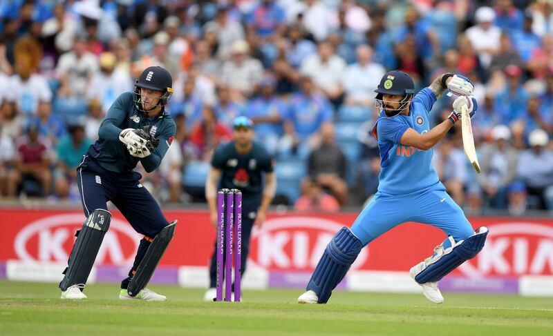 LEEDS, ENGLAND - JULY 17:  India batsman Virat Kohli hits out watched by Jos Buttler during 3rd ODI Royal London One Day match between England and India at Headingley on July 17, 2018 in Leeds, England.  (Photo by Stu Forster/Getty Images)