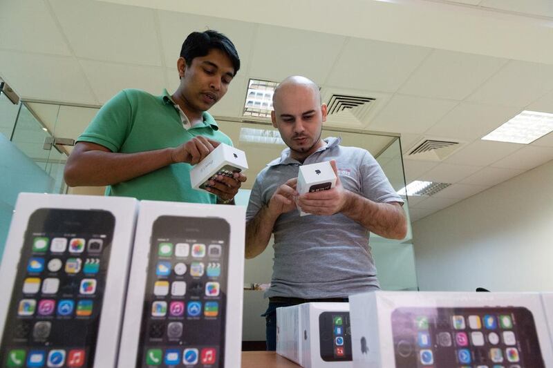 Arkan krait (right) about to purchase one of the first iphone 5s to be imported into the UAE from online store letstango.com. Duncan Chard for the national. *** Local Caption ***  DC0921-iphone_5s-0003.jpg