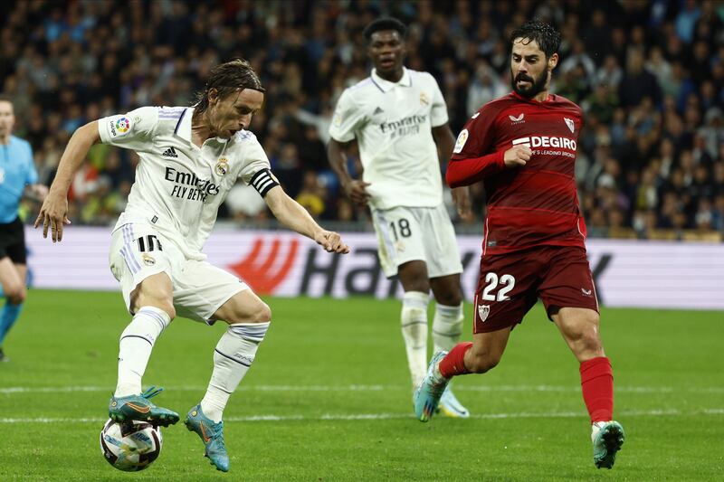 Luka Modric on the ball up against Sevilla midfielder Isco. EPA